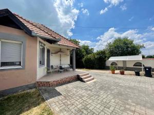 a house with a patio with a table and chairs at House and Apt in Keszthely Balaton 19032 in Keszthely +8 photos
