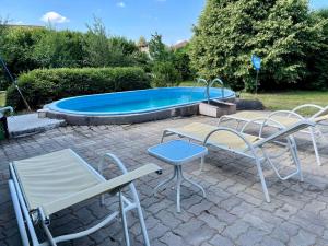 a patio with two chairs and a swimming pool at House and Apt in Keszthely Balaton 19032 in Keszthely