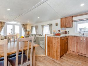 a kitchen and living room with a table and a dining room at Swona in Mey +15 photos