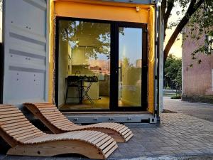 a store front with a bench in front of a window at Apartament Contandair in Olsztyn +2 photos
