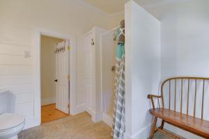 a bathroom with a toilet and a wooden bench at Lake Access and Views Peaceful Getaway in Conway in Conway +21 photos