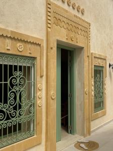 an entrance to a building with a gate at Dar Ellet Khadija in Sfax