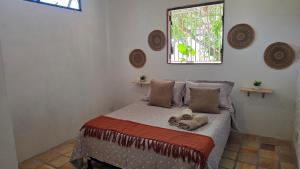 a bedroom with a bed with a window at Oceana Suites Pipa in Pipa +55 photos