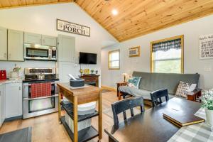 a kitchen and living room with a couch and a table at Cozy New York Abode - Porch, Near Fishing and Hiking in Jordan