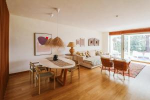 a living room with a table and chairs and a couch at Thirteen By The Sea in Troia