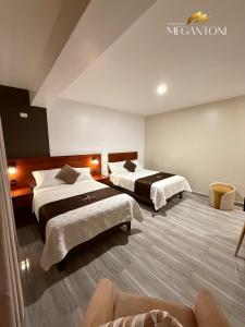 a large room with two beds and a couch at Grand Hotel Megantoni in Quillabamba