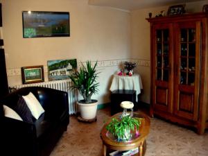 a living room with a couch and a table at La Grande Fontaine in Jugon Les Lacs