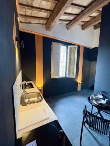 a kitchen with a sink and a table at UNIQUE Apartments in Faenza