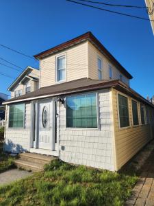 a white house with a door and windows at NWW single 2nd ave Hereford Inlet Anglesea in North Wildwood