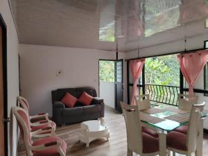 a living room with a couch and a table and chairs at Casa campestre in Fresno