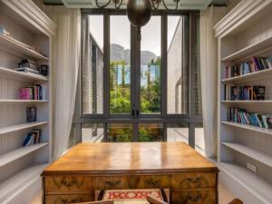 a table in a room with a large window at French Elegance in Bishopscourt in Cape Town