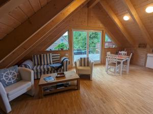 a living room with a couch and a table at Borner Holzhaus in Born