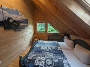 a bedroom with a bed in a wooden attic at Borner Holzhaus in Born