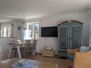 a living room with a table and a blue cabinet at Haus Wikinger in Born