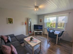 a living room with a couch and a table at Nussbaum in Wieck
