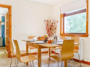 a dining room with a wooden table and chairs at Glen View Of Enrick House in Bearnock +25 photos