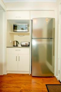 a kitchen with a stainless steel refrigerator and a microwave at Arnie's Place in Yarrawonga