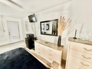 a living room with a dresser and a mirror at # 11 Cozy Mini House by the Lake in Canal Point