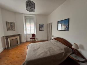 a bedroom with a bed and a fireplace at Maison 4 chambres, 2 étoiles, près plage, port de pêche – Les Sables-d'Olonne - FR-1-197-605 in Les Sables-dʼOlonne