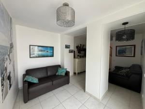 a living room with a couch and a chair at Maison 4 chambres, 2 étoiles, près plage, port de pêche – Les Sables-d'Olonne - FR-1-197-605 in Les Sables-dʼOlonne