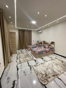 a bedroom with a bed and some rugs on the floor at الاسكندريه كينج مريوط in King Mariout +10 photos