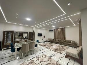 a living room with a table and a couch at الاسكندريه كينج مريوط in King Mariout