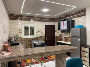 a kitchen with a counter top and a refrigerator at الاسكندريه كينج مريوط in King Mariout