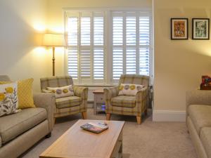 a living room with two chairs and a table at Princess Lodge in Scarborough
