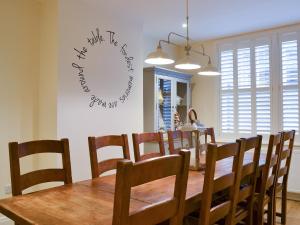 a dining room with a wooden table and chairs at Princess Lodge in Scarborough