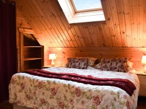 a bedroom with a bed in a wooden room at Foxglove- Uk48308 in Staintondale