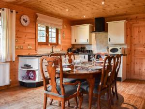 a kitchen with a table and chairs in a room at Foxglove- Uk48308 in Staintondale