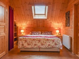 a bedroom with a bed in a wooden room at Foxglove- Uk48308 in Staintondale