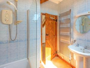 a bathroom with a tub and a sink and a shower at The Retreat - Uk48331 in Lifton