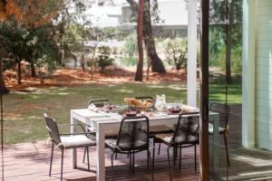 a white table with chairs on a patio at Thirteen By The Sea in Troia +65 photos