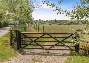 a wooden gate in the middle of a field at Firtree Farm Lodges in Yeovil