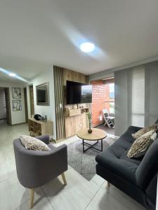 a living room with a couch and a table at San Silvestre Pereira in Pereira