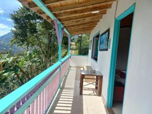a balcony of a house with a table and a view at Cabaña Noche De Luna in Jardin