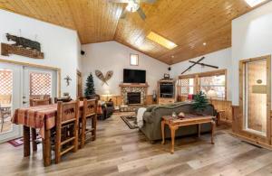 a living room with a couch and a table at Wren's Nest and Hot-Tub, Games with Best Location! in Big Bear Lake