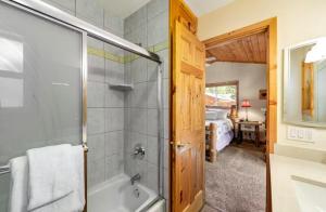 a bathroom with a shower and a bath tub at Wren's Nest and Hot-Tub, Games with Best Location! in Big Bear Lake +21 photos