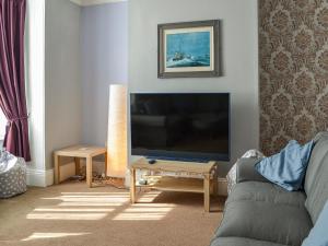 a living room with a large flat screen tv at Zack's Seaside Stay in Bridlington