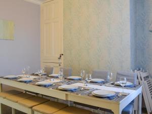 a dining table with glasses and plates on it at Zack's Seaside Stay in Bridlington +21 photos