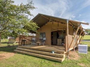 a small house with a porch and a patio at Mobil-home 6 pers avec Terrasse à Naucelle - API-1-52-325 in Naucelle