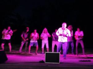 a group of people standing on a stage with pink lights at Chalet de 22m² avec Terrasse pour 4 personnes - API-1-52-414 in Saint-Sornin