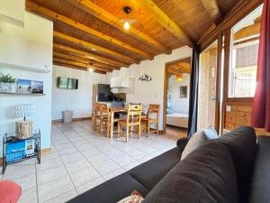 a living room with a couch and a table at Appartement cosy au Cernix près des pistes, 2 chambres, terrasse - FR-1-505-233 in Crest-Voland