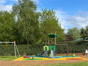a playground in a park with a slide at Mobile-home 6 pers avec terrasse à Naucelle - API-1-52-415 in Naucelle