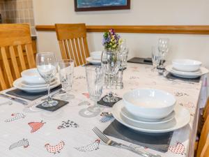 a table with plates and glasses on top of it at The Lodge in Lydney +22 photos