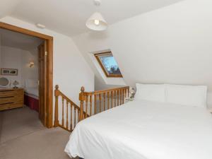 En eller flere senge i et værelse på Stable Cottage