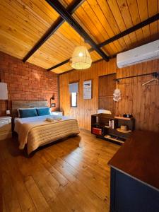 a bedroom with a bed in a room with wooden walls at Aerohouse in Posadas