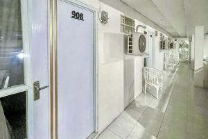 a white room with a door with the number on it at Urbanview Syariah Oemah Isun Homestay Cirebon by RedDoorz in Tangkil
