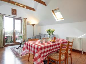 a living room with a table with a red and white table cloth at Wheal Trenwith Cottage in St Ives